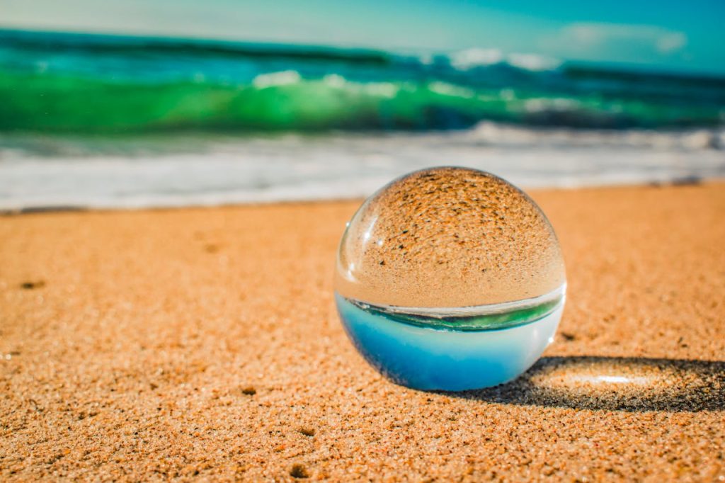 Mastering the First Impression: Your intriguing post title goes here Crystal ball on a serene Australian beach reflecting the ocean and sand, capturing the coastal essence.